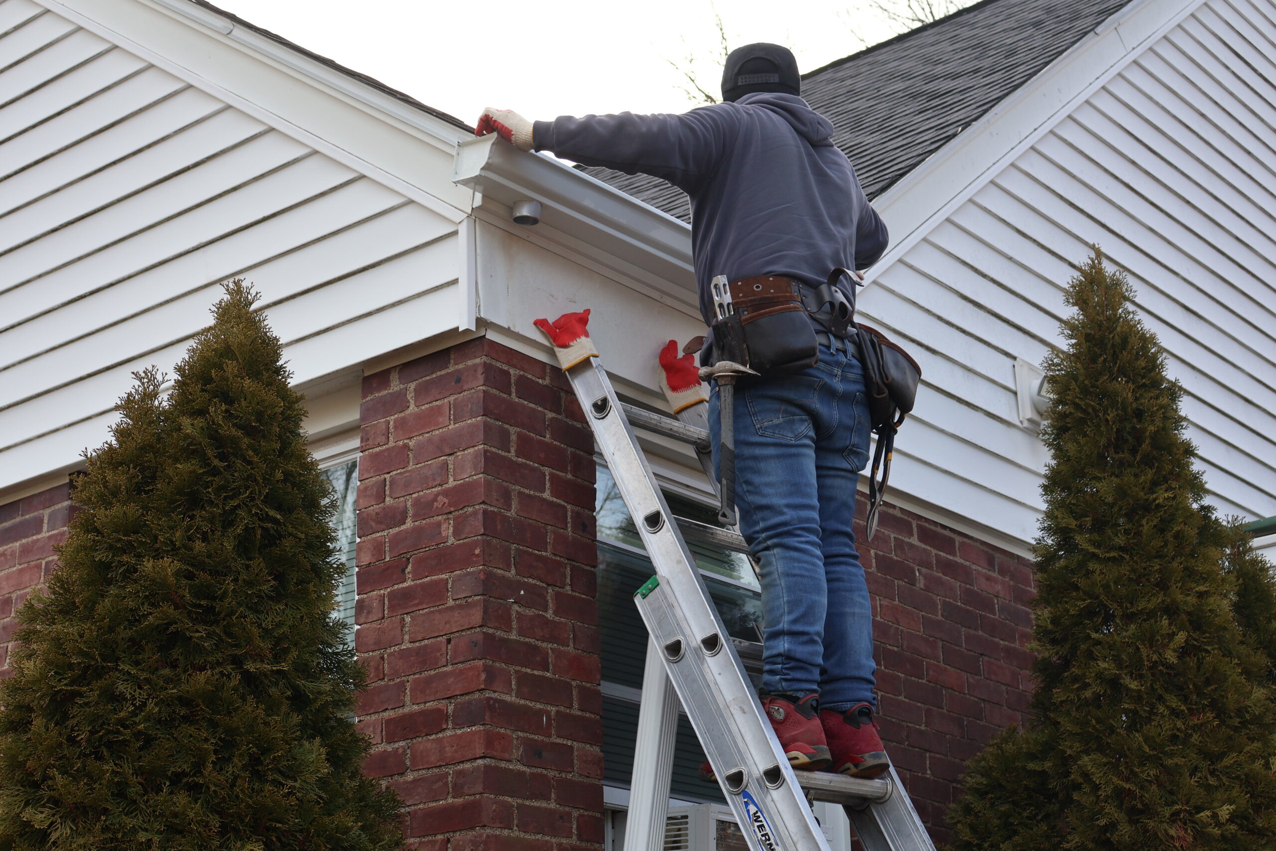 Technician performing roof repair on a residential property in Totowa, NJ​